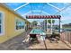 Screened pool and patio area with lounge chairs and awning at 721 Manns Harbor Dr, Apollo Beach, FL 33572