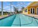 A screened-in pool with clear blue water, and views of the canal at 721 Manns Harbor Dr, Apollo Beach, FL 33572