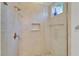 Walk-in shower featuring neutral tile, recessed shelf, showerhead and bronze fixtures at 721 Manns Harbor Dr, Apollo Beach, FL 33572
