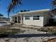 Backyard view showing the house and pool at 803 Bay Point Dr, Madeira Beach, FL 33708