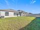 Spacious backyard with a grassy area and home view at 8849 Little Bluestem Dr, Land O Lakes, FL 34637
