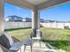 Cozy patio with seating area, overlooking a grassy backyard at 8849 Little Bluestem Dr, Land O Lakes, FL 34637