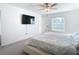 Bedroom with large TV and comfortable bed at 8849 Little Bluestem Dr, Land O Lakes, FL 34637