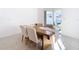 Dining area with wood table and chairs near sliding glass doors at 8849 Little Bluestem Dr, Land O Lakes, FL 34637