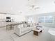 Open floor plan with white kitchen, island, and light living space at 8849 Little Bluestem Dr, Land O Lakes, FL 34637