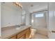 Clean bathroom with a tub, shower, vanity, and mirrored medicine cabinet at 11217 Avery Oaks Dr, Tampa, FL 33625