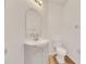 Clean bathroom with a white vanity, toilet and arched mirror at 11217 Avery Oaks Dr, Tampa, FL 33625