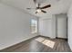 Bright bedroom with wood-look floors, ceiling fan, and double-door closet at 11217 Avery Oaks Dr, Tampa, FL 33625