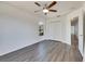 Bright bedroom with wood-look floors, ceiling fan, and double-door closet at 11217 Avery Oaks Dr, Tampa, FL 33625