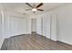 Spacious bedroom with wood-look floors, ceiling fan, and two double-door closets at 11217 Avery Oaks Dr, Tampa, FL 33625