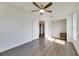 Spacious bedroom with wood-look floors, ceiling fan, and ample closet space at 11217 Avery Oaks Dr, Tampa, FL 33625