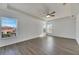 Sunlit bedroom with wood-look floors and multiple windows at 11217 Avery Oaks Dr, Tampa, FL 33625
