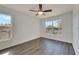 Well-lit bedroom with wood-look floors, ceiling fan, and large window at 11217 Avery Oaks Dr, Tampa, FL 33625