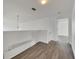 Upstairs hallway with wood-look floors and access to bedrooms at 11217 Avery Oaks Dr, Tampa, FL 33625