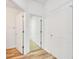 Clean hallway with white doors and wood flooring at 11217 Avery Oaks Dr, Tampa, FL 33625
