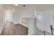 Upstairs hallway with light wood laminate flooring and access to bedrooms at 11217 Avery Oaks Dr, Tampa, FL 33625