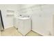 Laundry room with washer, dryer, and shelving at 11217 Avery Oaks Dr, Tampa, FL 33625