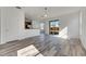 Bright living room featuring wood-look floors and sliding glass doors at 11217 Avery Oaks Dr, Tampa, FL 33625