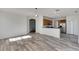Spacious living area with wood-look floors and kitchen access at 11217 Avery Oaks Dr, Tampa, FL 33625