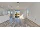 Bright living room featuring wood-look floors and sliding glass doors at 11217 Avery Oaks Dr, Tampa, FL 33625