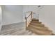 Modern staircase with wooden railing and carpeted steps at 11217 Avery Oaks Dr, Tampa, FL 33625