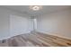 Spacious bedroom with double doors and wood-look floors at 11314 Leland Groves Dr, Riverview, FL 33579