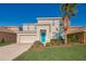 Two-story house with teal front door and landscaping at 11314 Leland Groves Dr, Riverview, FL 33579