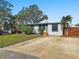 House exterior showcasing a large driveway and a nicely landscaped front yard at 133 80Th N Ave, St Petersburg, FL 33702