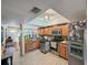 Bright kitchen features ample cabinetry and tile flooring at 133 80Th N Ave, St Petersburg, FL 33702