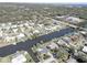 Aerial view of canal-front home in a residential neighborhood at 2179 Waterside Dr, Clearwater, FL 33764