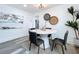 Bright dining area with modern table and chairs, hardwood floors, and stylish wall art at 2310 W Ivy St, Tampa, FL 33607