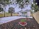 Large backyard with a concrete patio and wooden fence at 2310 W Ivy St, Tampa, FL 33607