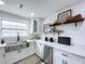 Modern white kitchen with stainless steel appliances and quartz countertops at 2310 W Ivy St, Tampa, FL 33607
