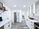 Modern white kitchen with stainless steel appliances and quartz countertops at 2310 W Ivy St, Tampa, FL 33607
