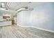 Open living room with kitchen view and wood-look floors at 2402 W Azeele St # 419, Tampa, FL 33609
