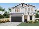 Two-story farmhouse style home with gray accents and landscaping at 501 S Clark Ave, Tampa, FL 33609