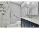 Updated bathroom with marble tile floors and a navy vanity at 5021 69Th N Way, St Petersburg, FL 33709