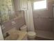 Bathroom with shower stall, toilet, sink, and grab bars at 6000 20Th N St # 114, St Petersburg, FL 33714