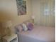 Bedroom with a double bed, nightstands, and artwork at 6000 20Th N St # 114, St Petersburg, FL 33714