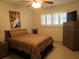 Comfortable bedroom with large window, ceiling fan, and dresser at 6000 20Th N St # 114, St Petersburg, FL 33714