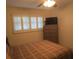 Spacious bedroom with large window, ceiling fan, and dresser at 6000 20Th N St # 114, St Petersburg, FL 33714