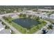 Aerial view of the community, showing buildings and a central lake at 6000 20Th N St # 114, St Petersburg, FL 33714