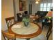 Dining area with a round table and four chairs, looking towards the living room at 6000 20Th N St # 114, St Petersburg, FL 33714