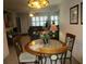 Small dining area with a round table and four chairs, adjacent to the living room at 6000 20Th N St # 114, St Petersburg, FL 33714