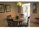 Dining area with a round table and four chairs, offering a view of the kitchen at 6000 20Th N St # 114, St Petersburg, FL 33714