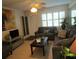 Living room with grey sofas, a coffee table, and a view of the entrance at 6000 20Th N St # 114, St Petersburg, FL 33714
