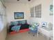 Sunroom with daybed, chair, and coastal decor at 6000 20Th N St # 114, St Petersburg, FL 33714