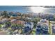 An aerial view showcases waterfront homes surrounded by lush palm trees and serene water views at 6010 Kipps Colony E Dr, Gulfport, FL 33707