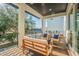 A covered outdoor balcony with outdoor sofa and chairs overlooking pool area at 6010 Kipps Colony E Dr, Gulfport, FL 33707