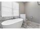 A soaking tub, modern faucet, floor-to-ceiling window, and toilet in a bathroom at 6010 Kipps Colony E Dr, Gulfport, FL 33707